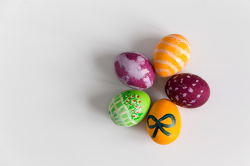 Easter colorful eggs on white background, top view