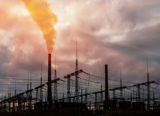 thermal power station plant industrial with trees at sunrise.
