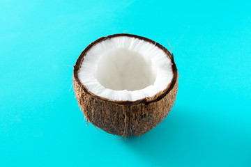 Half coconut fruit isolated on blue background
