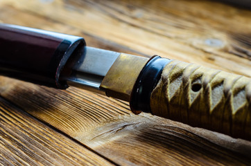 Japanese sword katana on wooden background