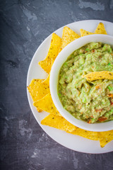 nachos with guacamole on a gray background