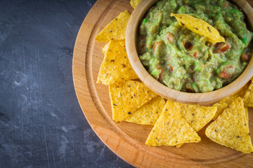 nachos with guacamole on a gray background