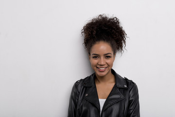 Close up of a smiling trendy brunette looking at camera