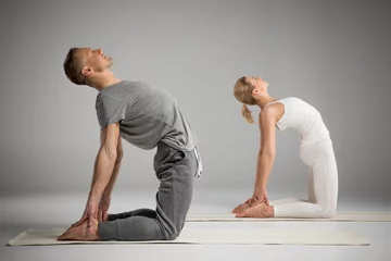 Fotobehang Couple standing in yoga pose © LIGHTFIELD STUDIOS