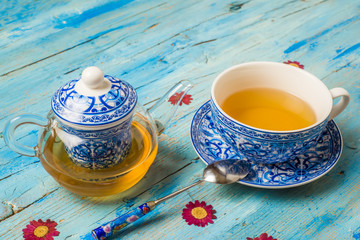 Transparent teapot and cup of tea