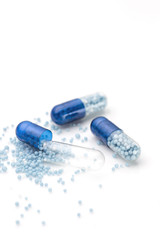 Blue capsules and pills background