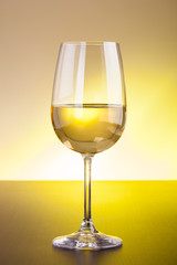 White wine glass on wooden table
