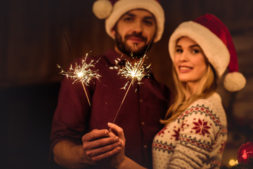 Couple holding sparklers