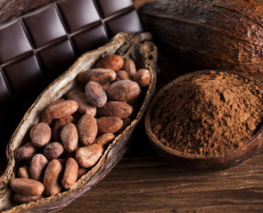 Cocoa pod and cocoa beans on the wooden table