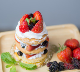 Beautiful women hold a mix berry cake in hand close up