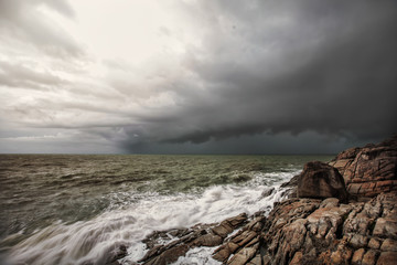 Sea storm. Big ocean wave breaking the shore, rain season in Asia