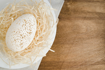 Table Setting for Easter Celebration. Carved Egg.