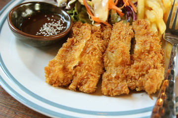 Fried pork steak on a table in a restaurant.