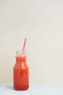 Healthy watermelon strawberry smoothie with paper straw