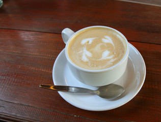 Hot coffee cup on table in the coffee shop.