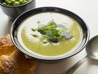 Green pea soup in bowl