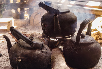 Black authentic teapots on fire