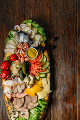 Food on dark wood background. Various snack.