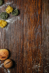 The wooden surface with macaroni and bread