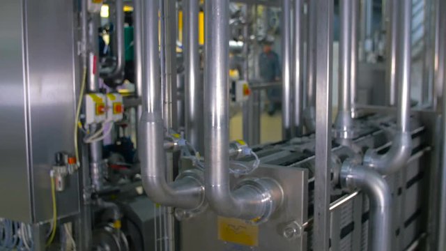 Modern, bright stainless steel pipeline at industrial plant. 4K.