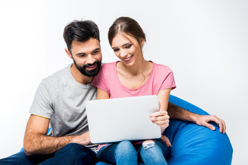 Young couple looking at laptop