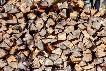 Stacked wood logs in pattern and rows