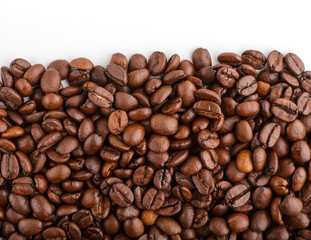 roasted coffee beans isolated in white background. Roasted coffee beans background close up. Coffee beans pile from top on white background with copy space for text. Good morning.