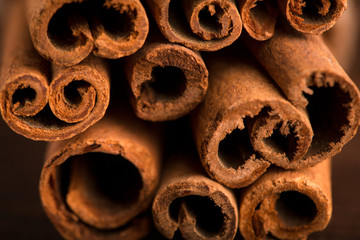 Cinnamon sticks and meal close up on wooden table. Cinnamon sticks spice close up background. Texture of cinnamon sticks.