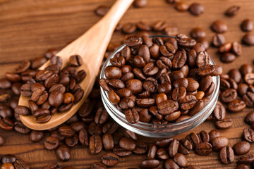 Coffee beans and cinnamon on a background of burlap. Roasted coffee beans background close up. Coffee beans pile from top with copy space for text. Seasoning. Spice. Cinnamon. Badian. Coffee house.