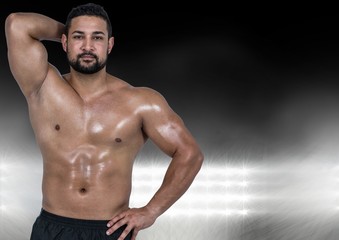 Fototapeta premium Muscular man posing against black illuminated background