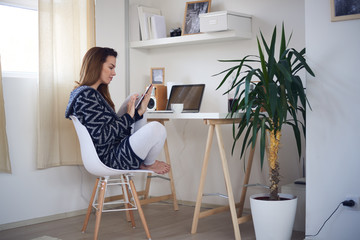 Young business girl in her personal workspace and working