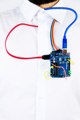 Virtual organs concept. Microcontrollers and chips connected to the body of a man simulating heart's activity