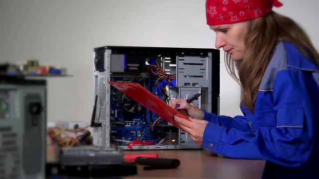 computer specialist woman install ram memory to stationary computer