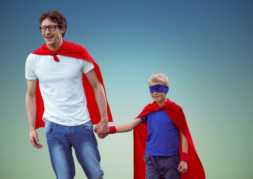 Father and son in superhero costume against blue background