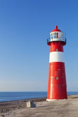 Foto auf Acrylglas Red and white lighthouse and a clear blue sky © sara_winter