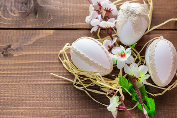 Beautiful Easter eggs with flowers on the wooden background