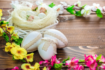 Beautiful Easter eggs with flowers on the wooden background