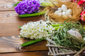 Fototapeta na wymiar Beautiful Easter eggs with flowers hyacinths on the wooden background