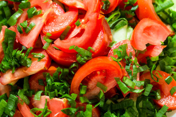 Background of tomato salad with green onions, black pepper and olive oil