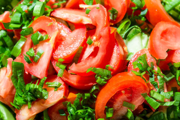 Background of tomato salad with green onions, black pepper and olive oil
