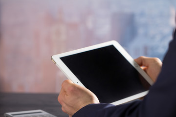 Man witch tablet in office Dubai backbround