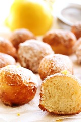 Ricotta Donuts ( Fritters) dusted with powdered sugar on white background, selective focus