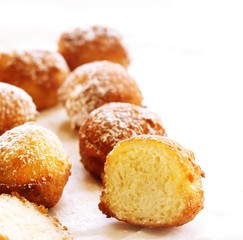 Ricotta Donuts ( Fritters) dusted with powdered sugar on white background, selective focus