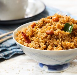 Quinoa Puliyogare or Puliyodharai served in a bowl, selective focus
