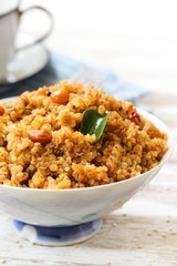 Quinoa Puliyogare or Puliyodharai served in a bowl, selective focus