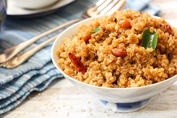 Quinoa Puliyogare or Puliyodharai served in a bowl, selective focus