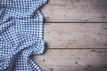 Blue checkered tablecloth on an old wooden table