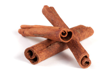three cinnamon sticks isolated on white background