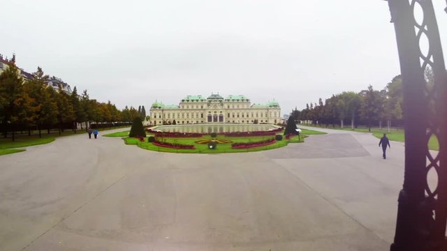 Belvedere Palace aerial fly through gates, famous tourist attraction, Austria capital sight seeing, royal Belvedere residence, marble lions and drums, garden and pond  fly over, travel tour place
