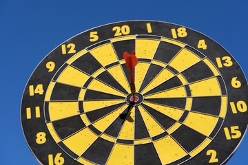 Target & Success concept : Dartboard Close Up on blue sky background.
Smart goal setting, dart hit...